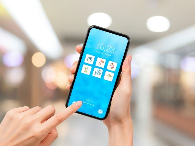 Image for the blog post titled 'Why your brain works a lot like your smartphone hoe screen' by Avril Kidd. A mobile phone screen showing 6 brain talent 'applications'. A hand is holding the phone while another hand is touching the screen.